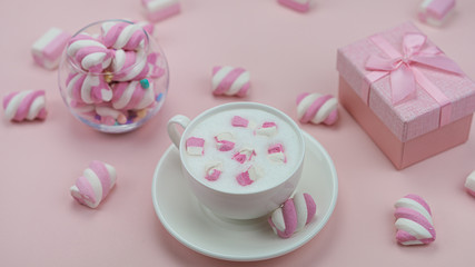 Pink marshmallows with a delicious hot drink. Little girl's Breakfast.