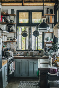 Old Crampy Rustic Kitchen With Small Window In A Tropical House With Straw Roof.