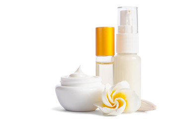 Beautiful flowers and bottles with natural skincare cream isolated on white background