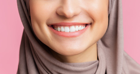 Wide smile with perfect teeth of muslim girl in hijab, closeup