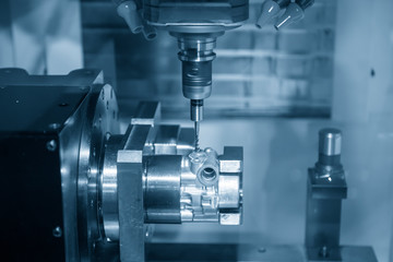 The  multi-axis  CNC milling machine  tapping the thread at the aluminium casting parts by tapping tool . The 4-axis machining center  machine automotive parts on the rotary table.