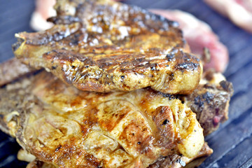 preparing meat on a coal barbeque