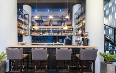 Half-lighted hall in a loft style in urban cafe with open bar counter