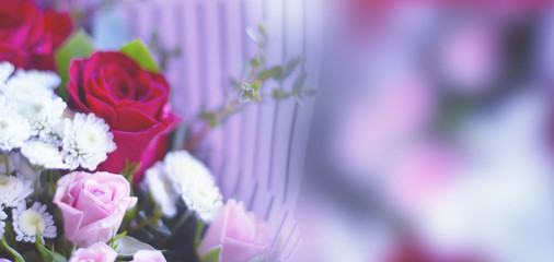 Delicate floral background with copy space under the text. Blurred background with spring flowers, bokeh. Bouquet of flowers close-up