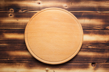pizza cutting board at rustic wooden plank background