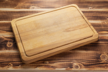 cutting board at rustic wooden plank background