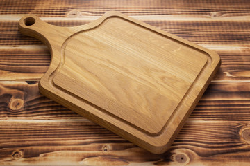 cutting board at rustic wooden plank background