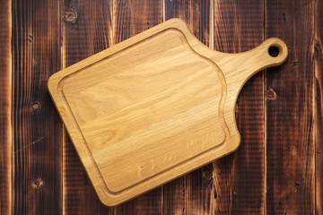 cutting board at rustic wooden plank background