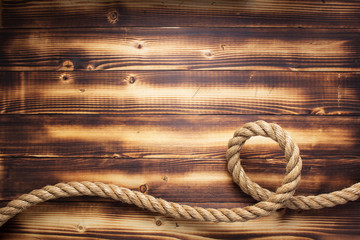 Fototapeta na wymiar ship rope at wooden background