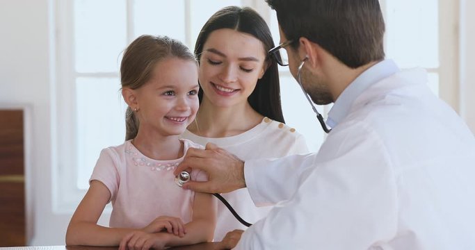 Male pediatrician holding stethoscope exam little child girl patient
