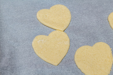 Obraz premium Hearts shape cookies cooking process. Valentines day gift preparation dating.
