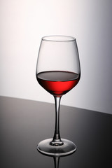 Red Wine Glass on Black Table and White Background