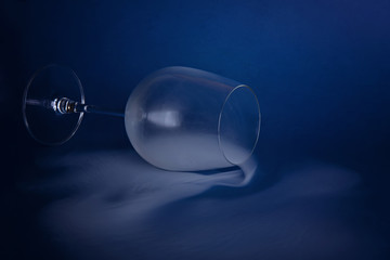 Large wine glasses with smoke on a blue background. Color of the year 2020, Classic Blue.