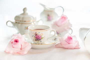 Tea time served with  fine china porcelain set with floral pattern. 