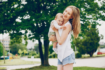 Mother with a baby. Walking in the park. Family relationship.