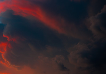 Fototapeta na wymiar Red and black clouds in sunset sky (background)