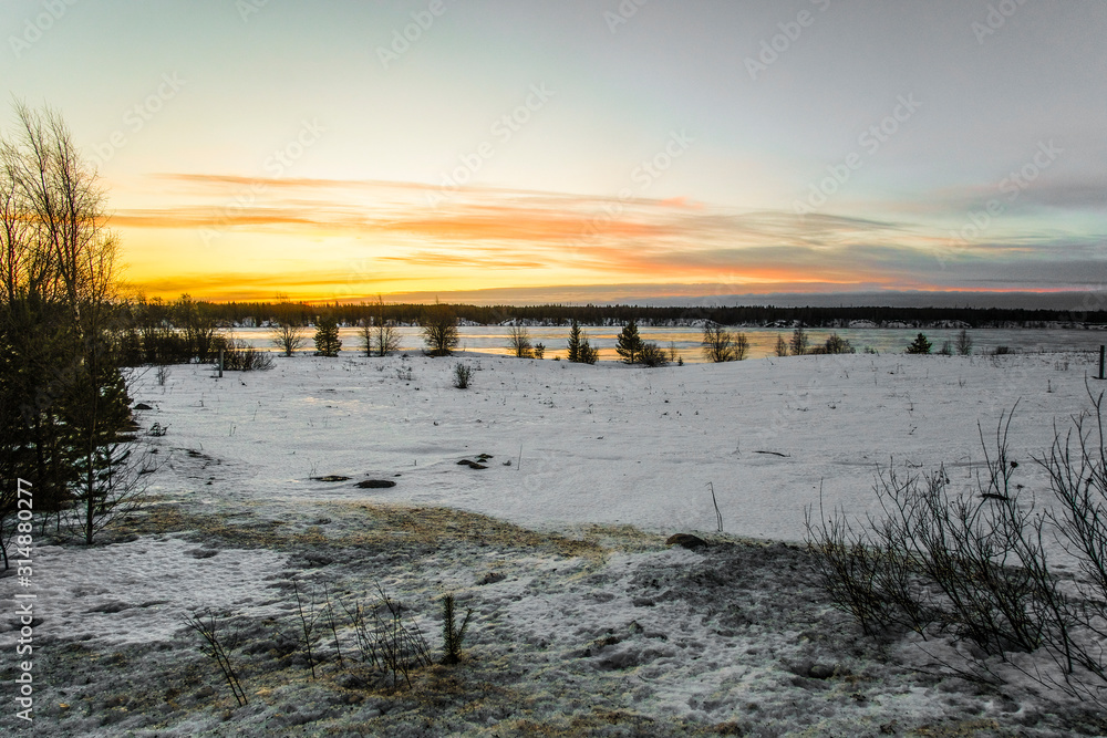 Poster landscape with the image of the ice covered frozen river kem in karelia, russia