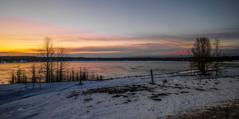 Landscape with the image of the ice covered frozen river Kem in Karelia, Russia