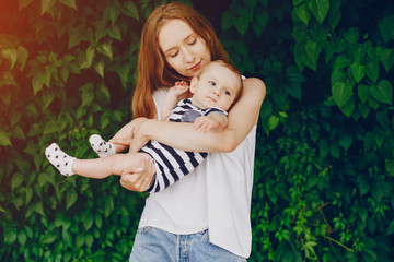 Mother with a baby. Walking in the park. Family relationship.