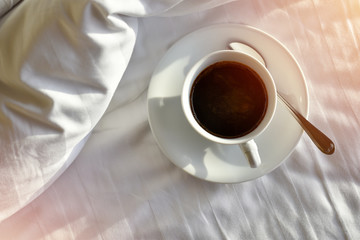High angle view, Morning coffee on a white bed with sunrise.