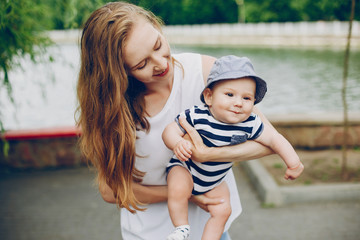 Mother with a baby. Walking in the park. Family relationship.