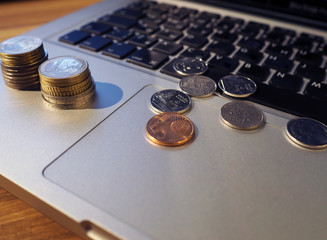 coins on the laptop keyboard