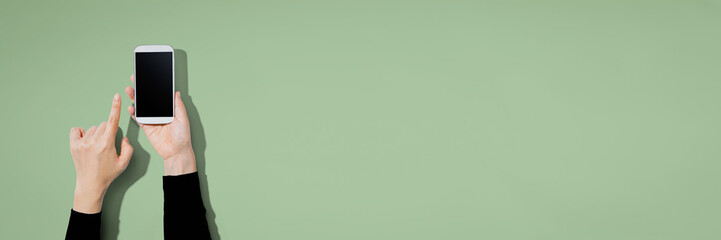 Person using a white smartphone with copyspace