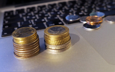 coins on the laptop keyboard