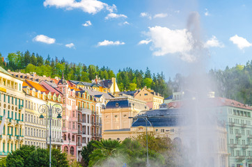 Hot spring geyser Vridlo at Karlovy Vary Carlsbad historical city centre, colorful beautiful...