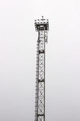 old lighting mast, spotlight, metal tower for a small local football field
