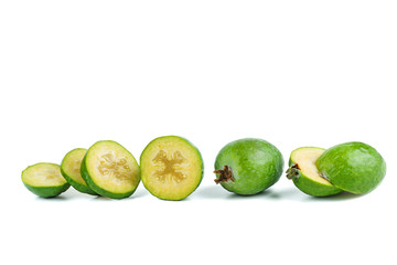 Whole and sliced feijoa fruits isolated on white background