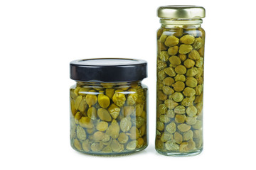 Glass jars with marinated capers isolated on the white background