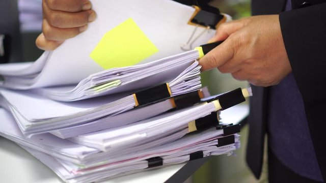 Documents or paperwork,report file information searching by businesswoman in office concept: Business people working of arranging of financial stack folder,check accounting budget storage in tax audit