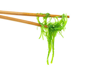 Wakame seaweed and chopsticks isolated on white background © Roman Ivaschenko