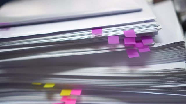 Stack of overwork of document report with post-it in business busy concept: Piles of paper files with postit on paperwork in overload at modern office
