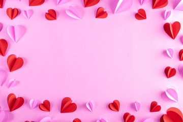 Pink and red hearts on pastel pink paper background. Copy space. Valentines day, Women's day, Mother's day concept.