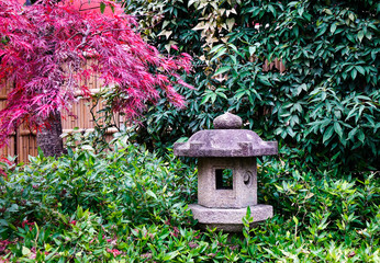Stone lantern at small autumn garden