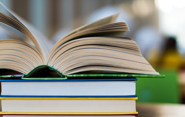 Open book lying on the table in the library