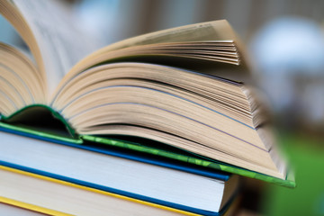 Open book lying on the table in the library