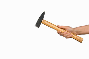 Hand holding a steel and wood hammer isolated on white background. Arm of construction worker in building industry. Manual tool for home repair. 