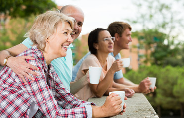 pensioners talking in the park and drinking coffee