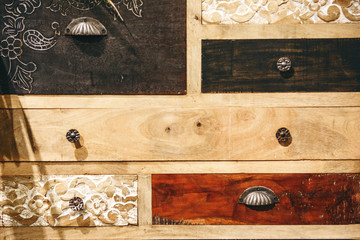 Close up of vintage wooden locker or cabinet or other furniture with closed drawers