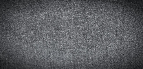 Dark grey or gray grass field or lawn for background in black and white tone. Art textured wallpaper and Detailed of surface concept  