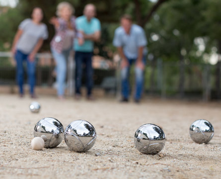 Image of people playing petanque on sand