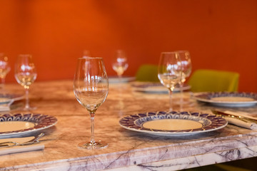 Empty glasses in restaurant. Wine glass,banquet ,dining table settings decoration serving with dishes, glass, napkins on wooden dining table interior contemporary concept.Part of interior