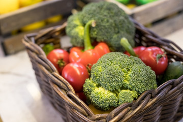 Fresh vegetables in basket on the table. red tomatoes, broccoli, potato, peppers,red paprika. Bio Healthy food, herbs and spices. Organic vegetables. Selective focus.