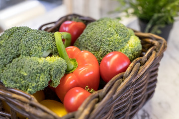 Fresh vegetables in basket on the table. red tomatoes, broccoli, potato, peppers,red paprika. Bio Healthy food, herbs and spices. Organic vegetables. Selective focus.