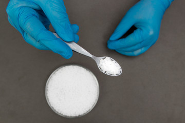 Plastic granules . Polypropylene, polyethylene pellets in hands with gloves. Quality control of plastic in the laboratory in production