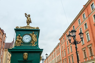 Antique clock on the street. The sky of Russia.