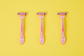 Pink razor for women. Safe shaving with a sharp razor of female skin. Hair removal from the legs and face. Body care and beauty of a woman